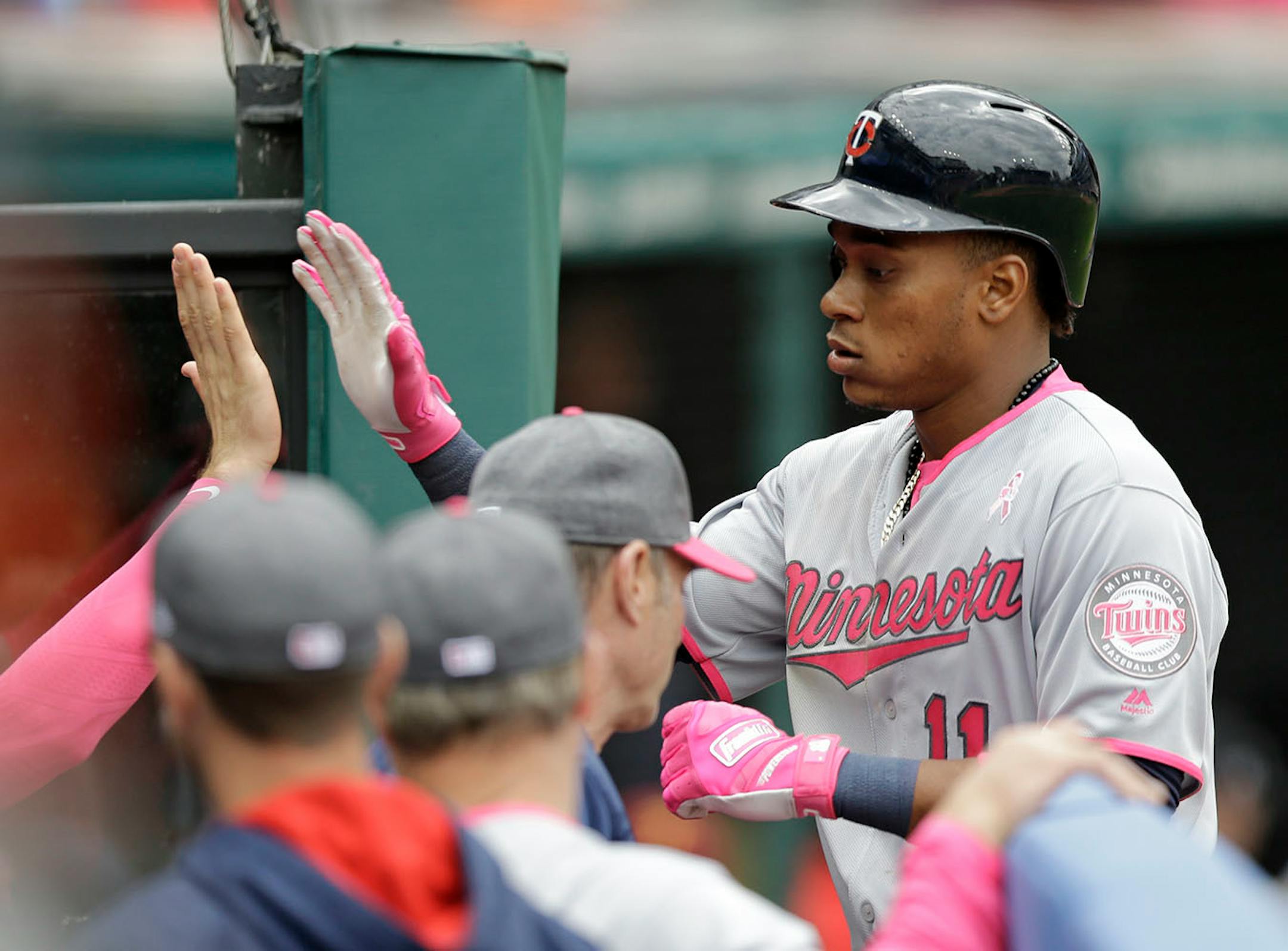 Minnesota Twins' Jorge Polanco is congratulated by teammates after hitting a solo home run off Cleveland Indians starting pitcher Trevor Bauer in the seventh inning of a baseball game, Sunday, May 14, 2017, in Cleveland.