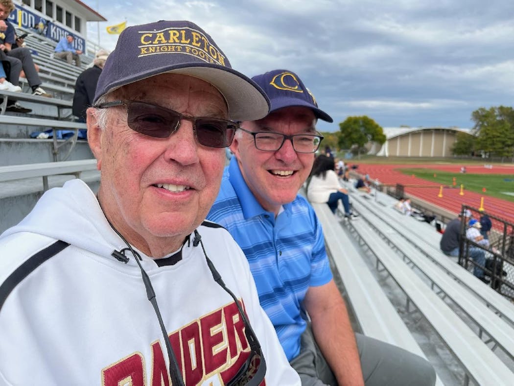 Former Carleton coach Bob Sullivan sat with former Knights captain Paul Moore at Saturday’s game. On Oct. 15, the field will be renamed in Sullivan’s honor.