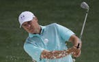 Jordan Spieth hits from a bunker on the 18th hole during a practice round for the Masters golf tournament Wednesday, April 4, 2018, in Augusta, Ga. (A