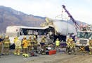 FILE - This Oct. 23, 2016 file photo shows emergency personnel working the scene where a tour bus crashed into the rear of a semi-truck on westbound I