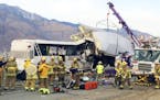 FILE - This Oct. 23, 2016 file photo shows emergency personnel working the scene where a tour bus crashed into the rear of a semi-truck on westbound I