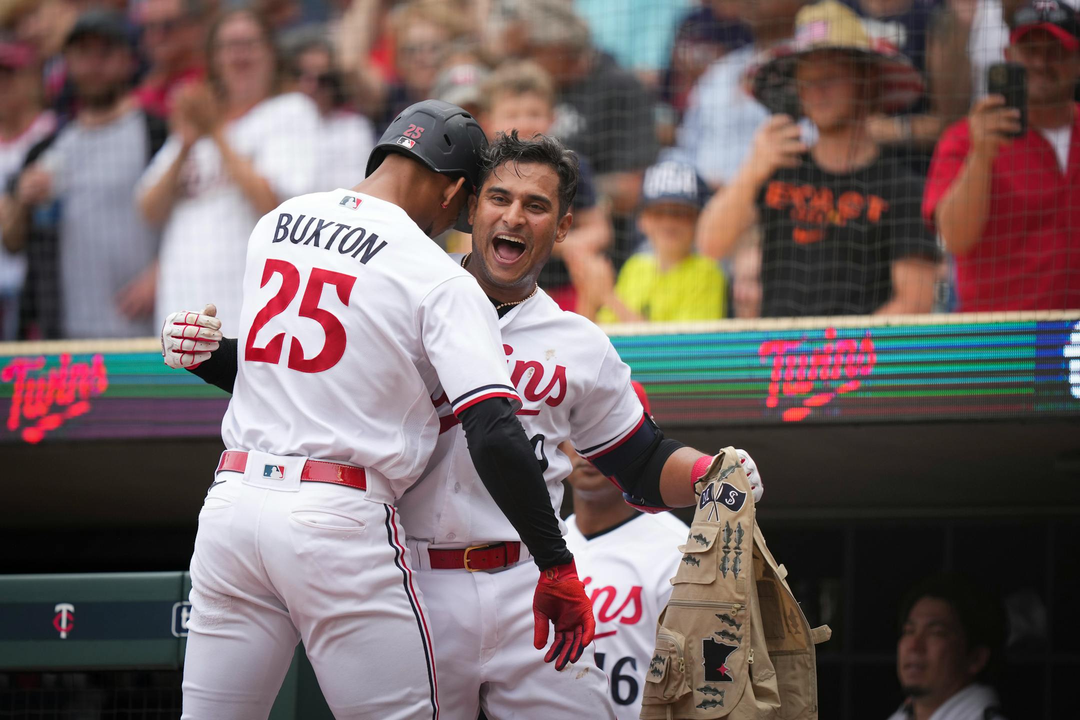 Minnesota Twins designated hitter Byron Buxton (25) and Minnesota Twins second baseman Donovan Solano (39) celebrate at the dugout after getting back to back solo home runs in the fifth inning.