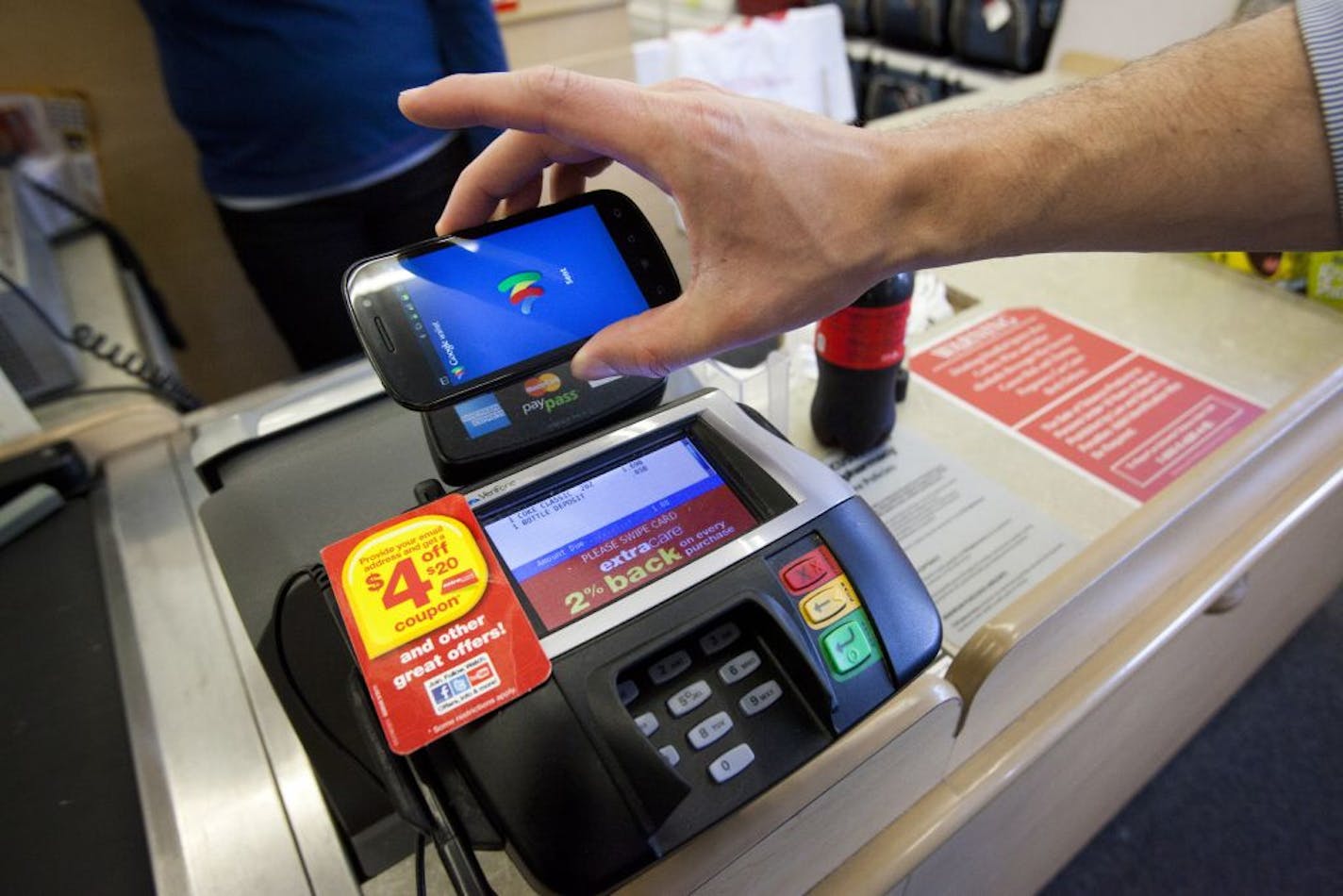 An executive with the Google Wallet project showed in Mountain View, Calif., how customers will be able to use their smartphones to pay for a purchase.