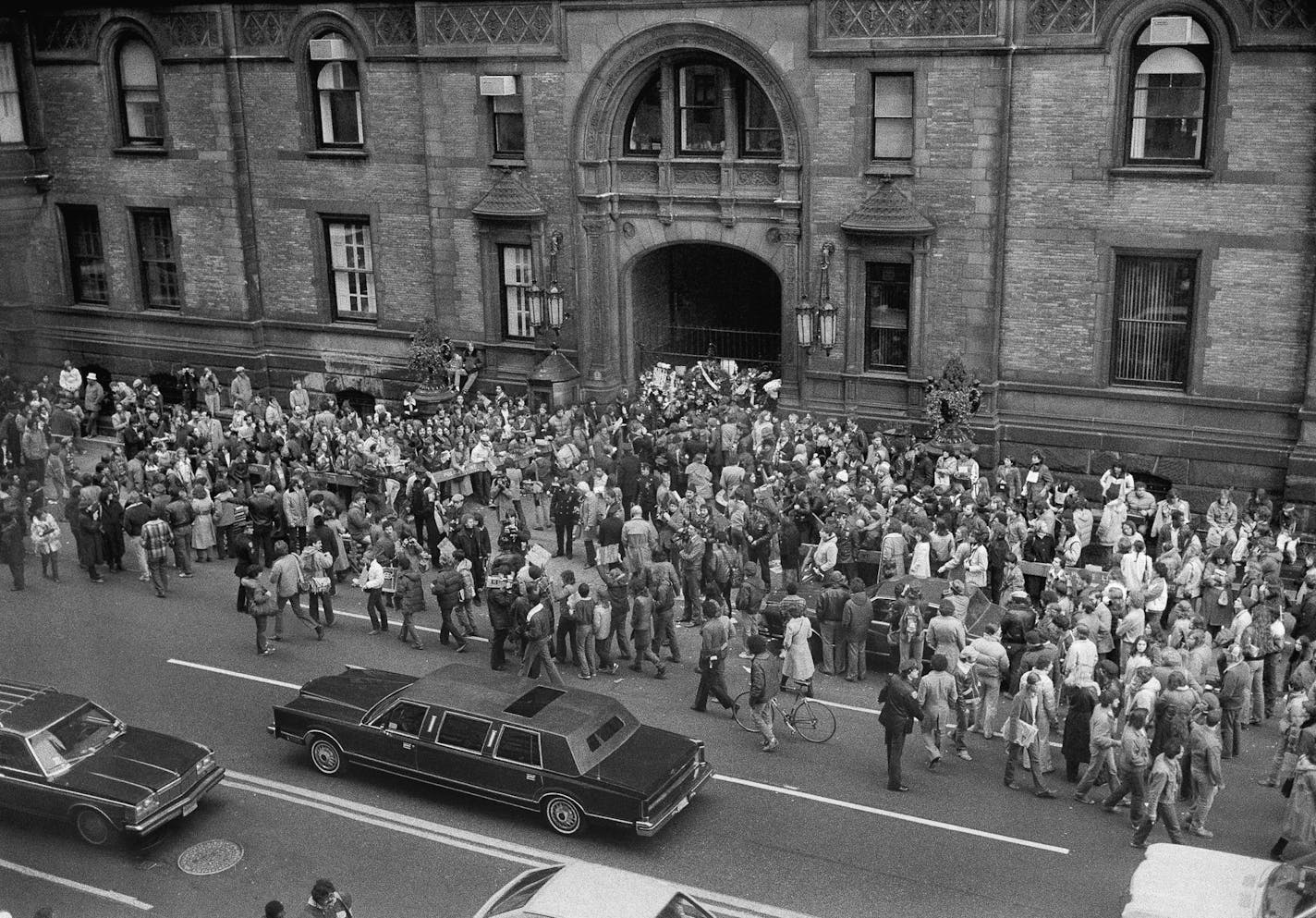 Fans and mourners gathered outside the Dakota on Dec. 9, 1980, the day after John Lennon was shot near this entrance.	New York Times