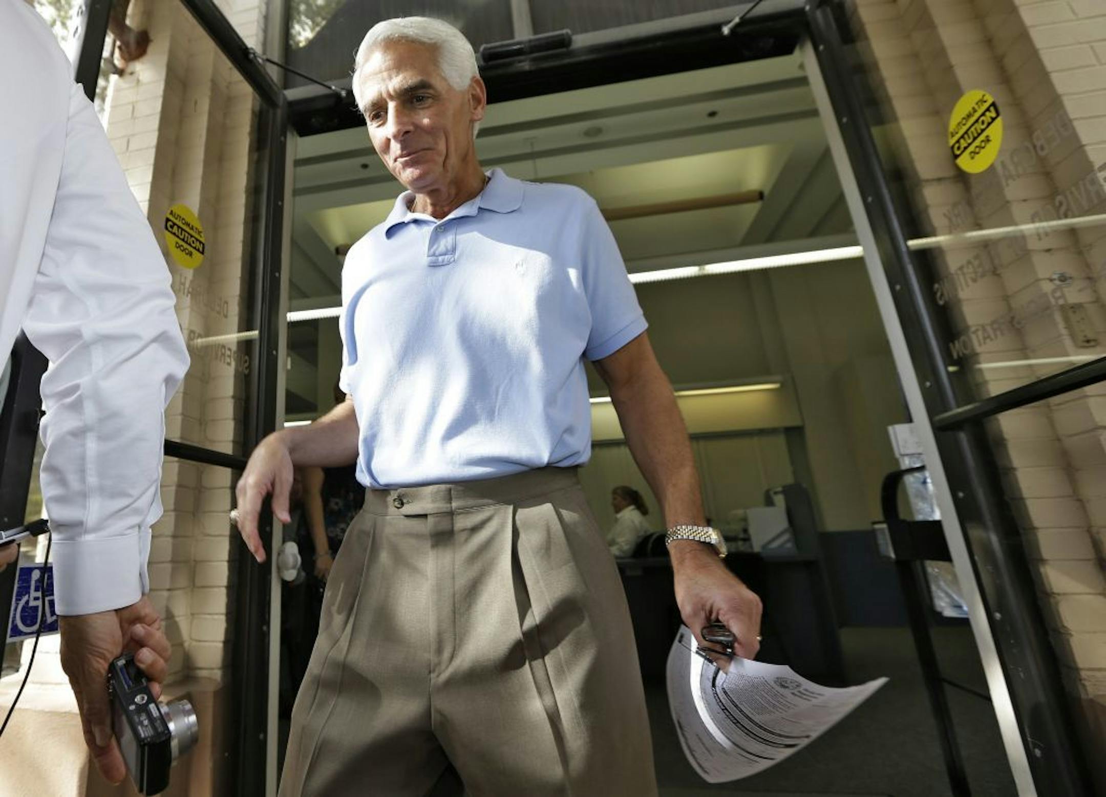 Former Republican Florida Governor Charlie Crist, leaves the Pinellas County Supervisor of Elections Thursday, Dec. 13, 2012, in St. Petersburg, Fla. Crist officially switched his party affiliation to the Democrat party, fueling speculation that he will run for governor again.