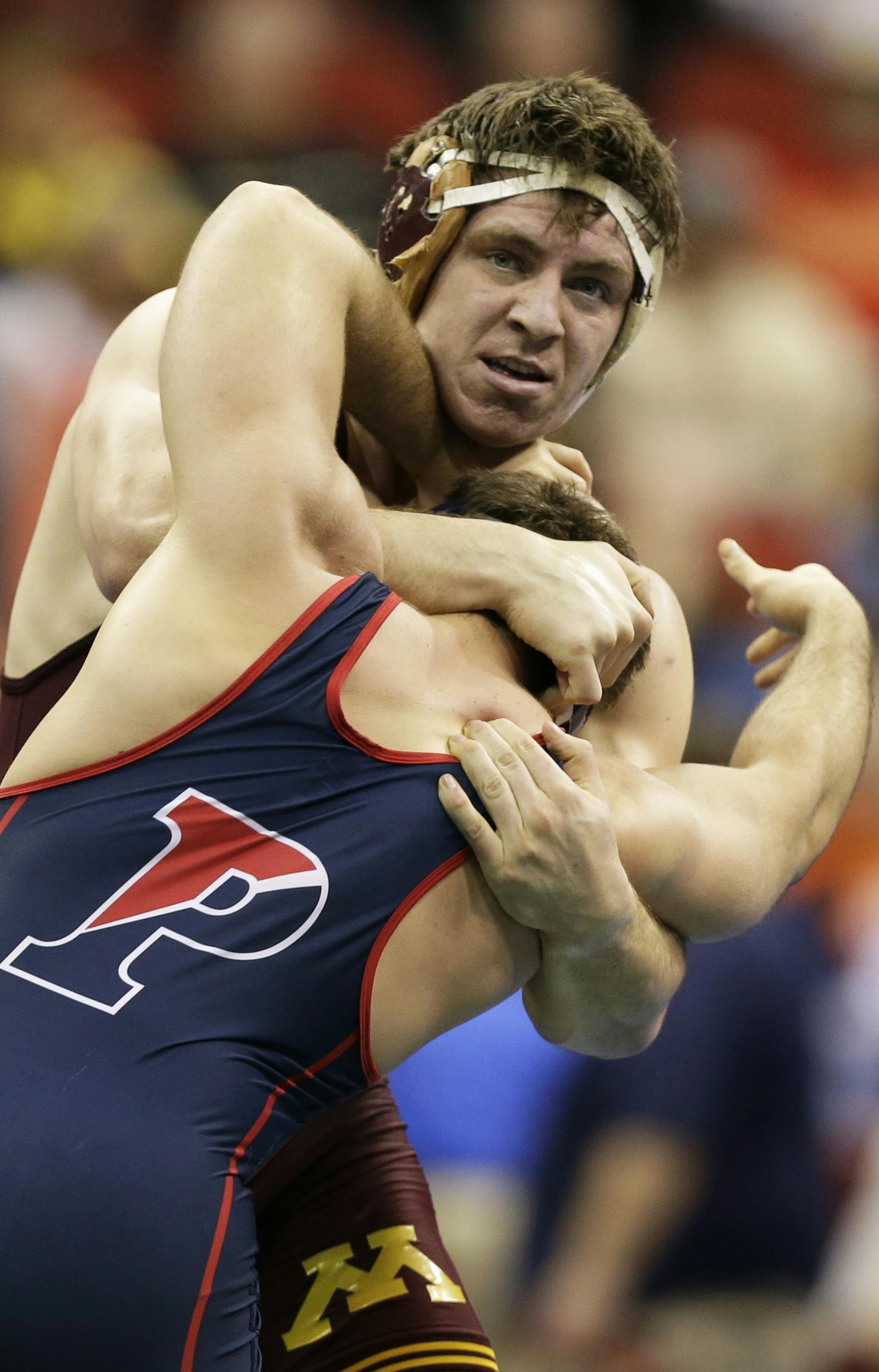Minnesota's Anthony Nelson, top, tries to take down Pennsylvania's Steven Graziano during their 285-pound match at the NCAA division I wrestling championships on Thursday, March 21, 2013, in Des Moines, Iowa. (AP Photo/Charlie Neibergall)