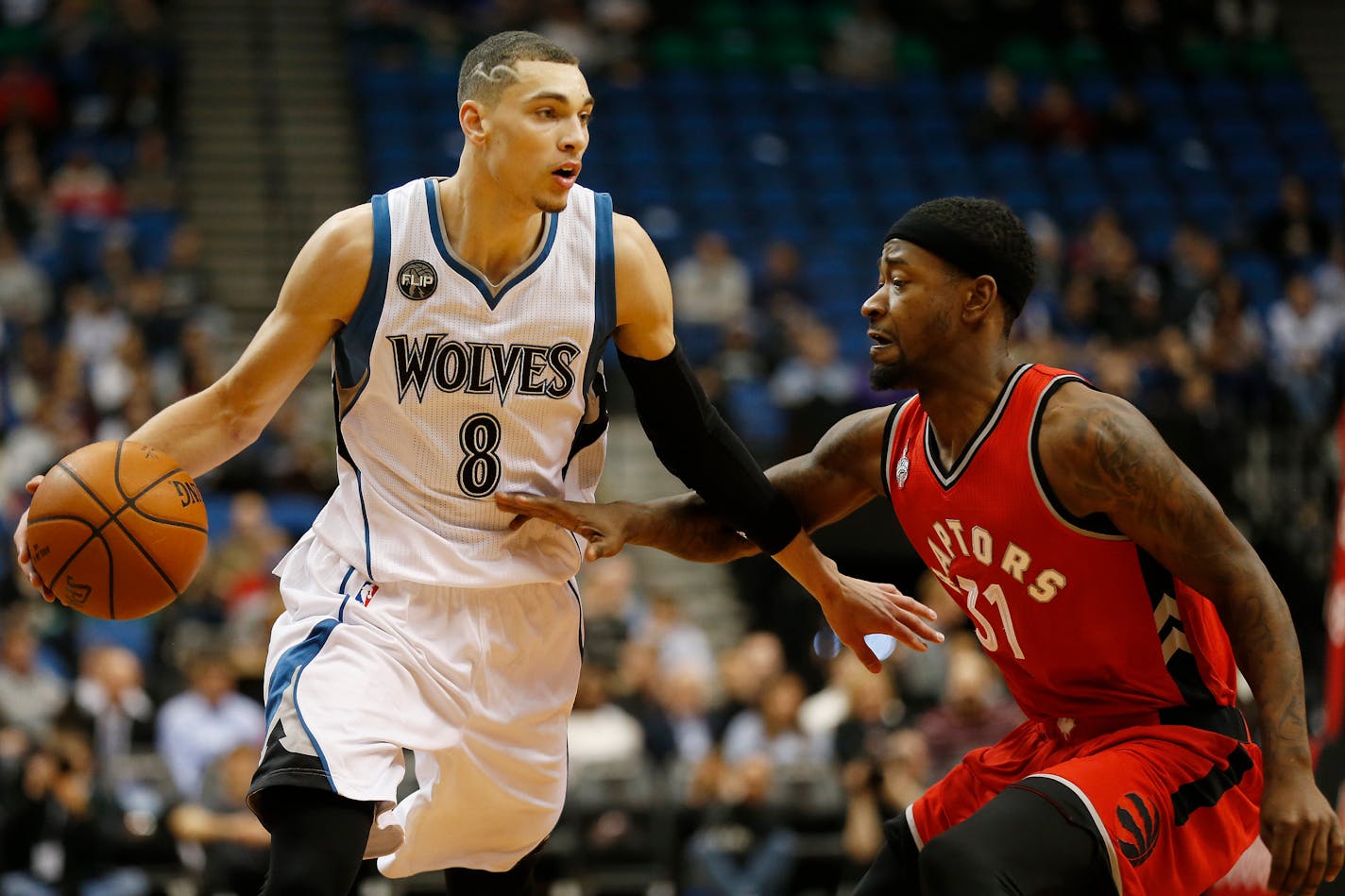 Minnesota Timberwolves guard Zach LaVine (8) controls the ball against Toronto Raptors guard Terrence Ross (31) in the first half of an NBA basketball game Wednesday, Feb. 10, 2016, in Minneapolis. (AP Photo/Stacy Bengs)