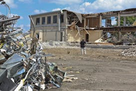 Estimator project manager Andy Ristrom watched the demolition of building 105, an administration building, at the Twin Cities Army Ammunition Plant in