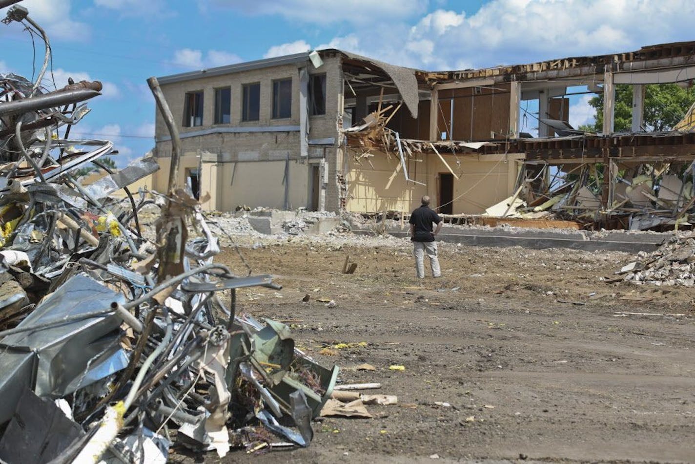 Estimator project manager Andy Ristrom watched the demolition of building 105, an administration building, at the Twin Cities Army Ammunition Plant in Arden Hills, Minn., on Tuesday, June 18, 2013.