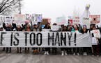 Students held signs as they gathered at Harriet Island Regional Park in St. Paul on March 24 before matching to the State Capitol protesting gun viole