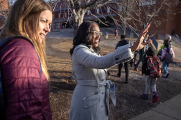 New superintendent of Minneapolis Public Schools, Lisa Sayles-Adams, alongside Principal Anne Wagemaker, left, greeted students as they get off the bu