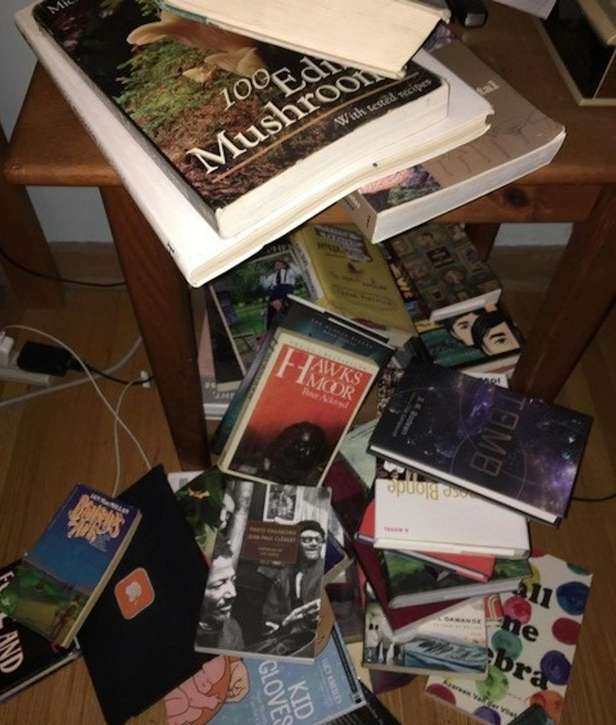 The books on Pete Hautman's bedside table spill onto the floor.
