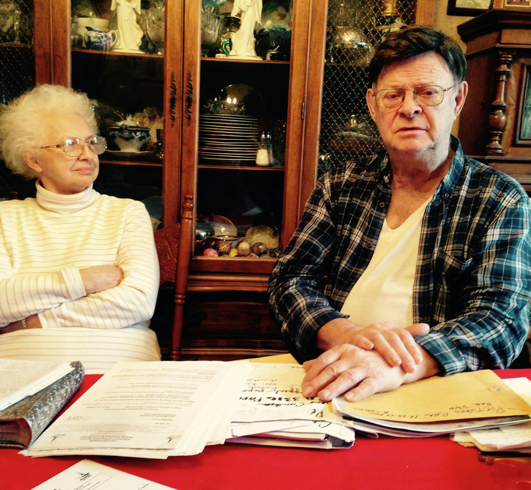 Andrew Ellis and his wife, Harriet, sitting at a table in their south Minneapolis house. Ellis is looking at orders for repairs for alleged violations on one of his south Minneapolis properties. Ellis calls many of the allegations â€œbogus.â€ He calls the city inspections office â€œincompetentâ€ and says â€œthey are harassing the hell out of me.â€ Ellis, with his wife, have sued the city i