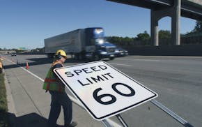 MnDOT worker Lisa Weidema assembled a new 60 MPH sign in preparation to erecting it on Hwy 100 just south of 36th Av. N. GENERAL INFORMATION: Duane Br