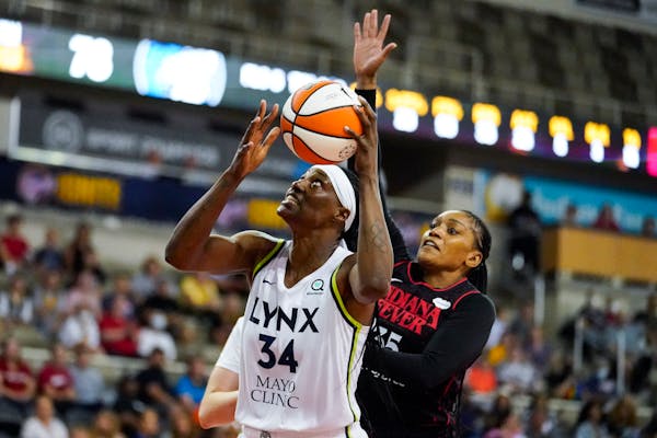 Minnesota Lynx center Sylvia Fowles (34) is fouled as she shoots by Indiana Fever guard Victoria Vivians (35) in the second half of a WNBA basketball 