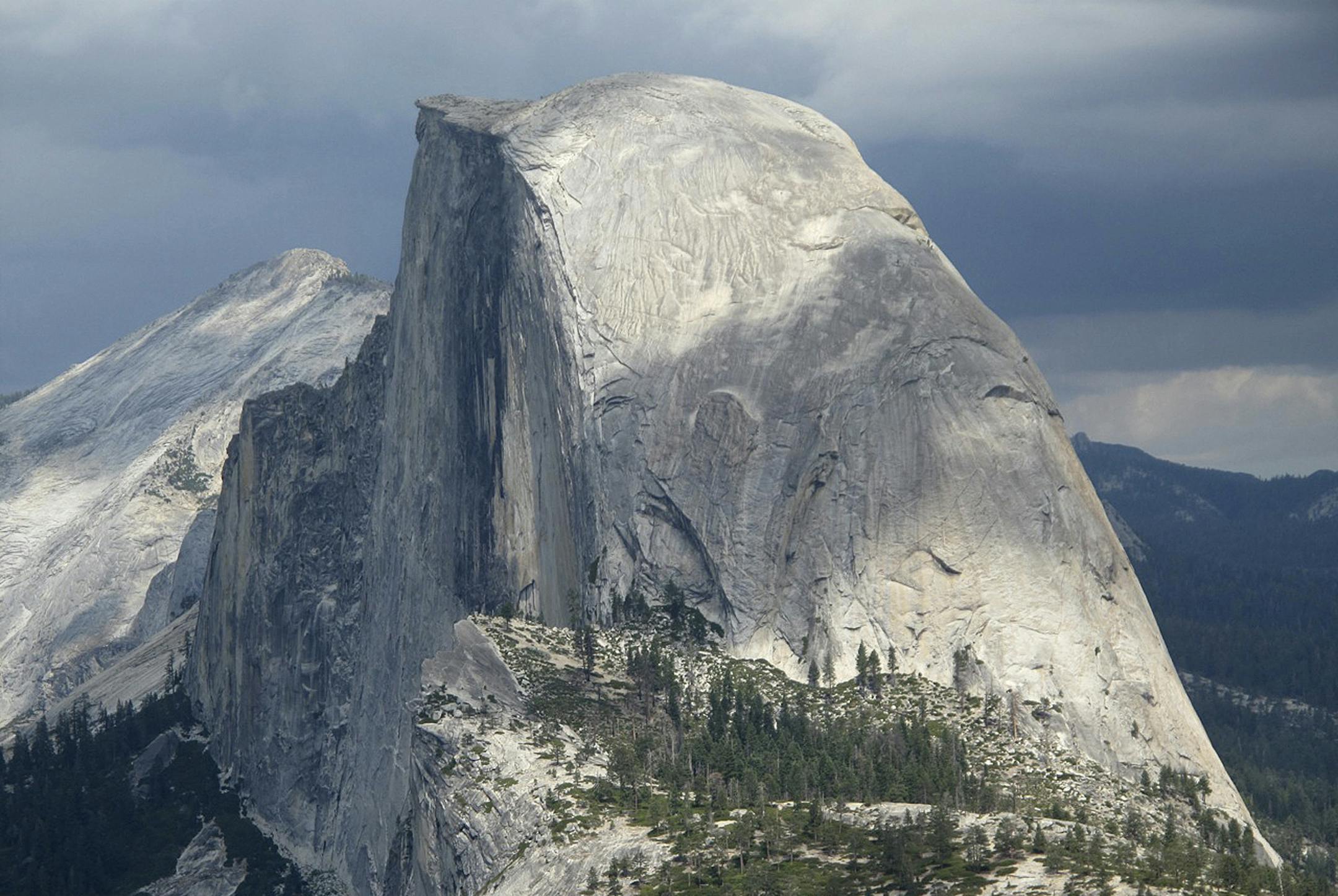 FILE - This August 2011 file photo shows Half Dome and Yosemite Valley in a view from Glacier Point at Yosemite National Park, Calif. A massive sheet of rock has fallen from the vertical face of Half Dome in Yosemite National Park, making one of the most popular routes attempted by climbers in North America even more challenging, park officials said Tuesday, July 7, 2015. (AP Photo/Tracie Cone, File)