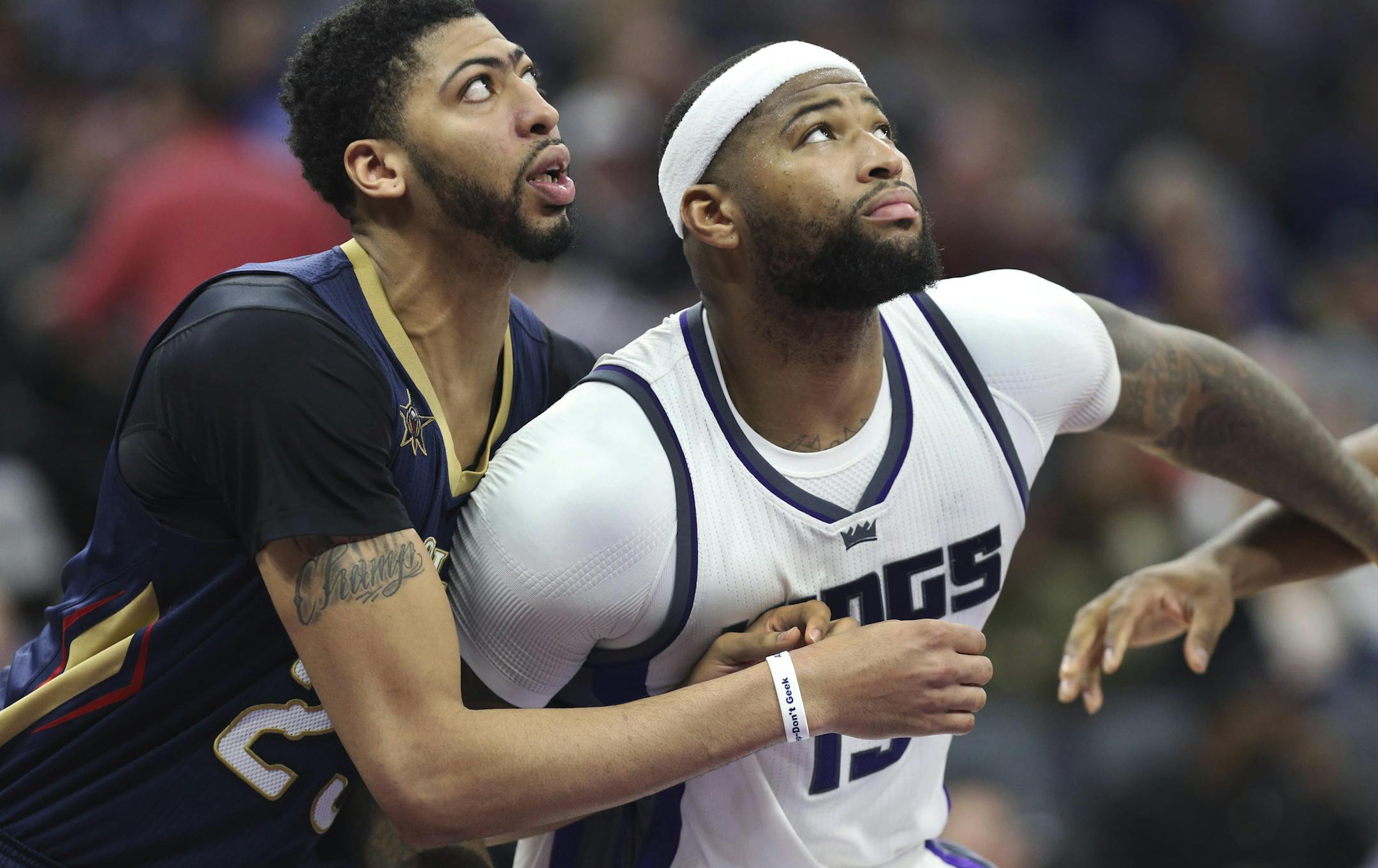 Sacramento Kings center DeMarcus Cousins (15) and New Orleans Pelicans center Anthony Davis (23) battle for position under the basket during the second half of an NBA basketball game in Sacramento, Calif., Sunday, Feb. 12, 2017. The Kings won 105-99. (AP Photo/Steve Yeater)