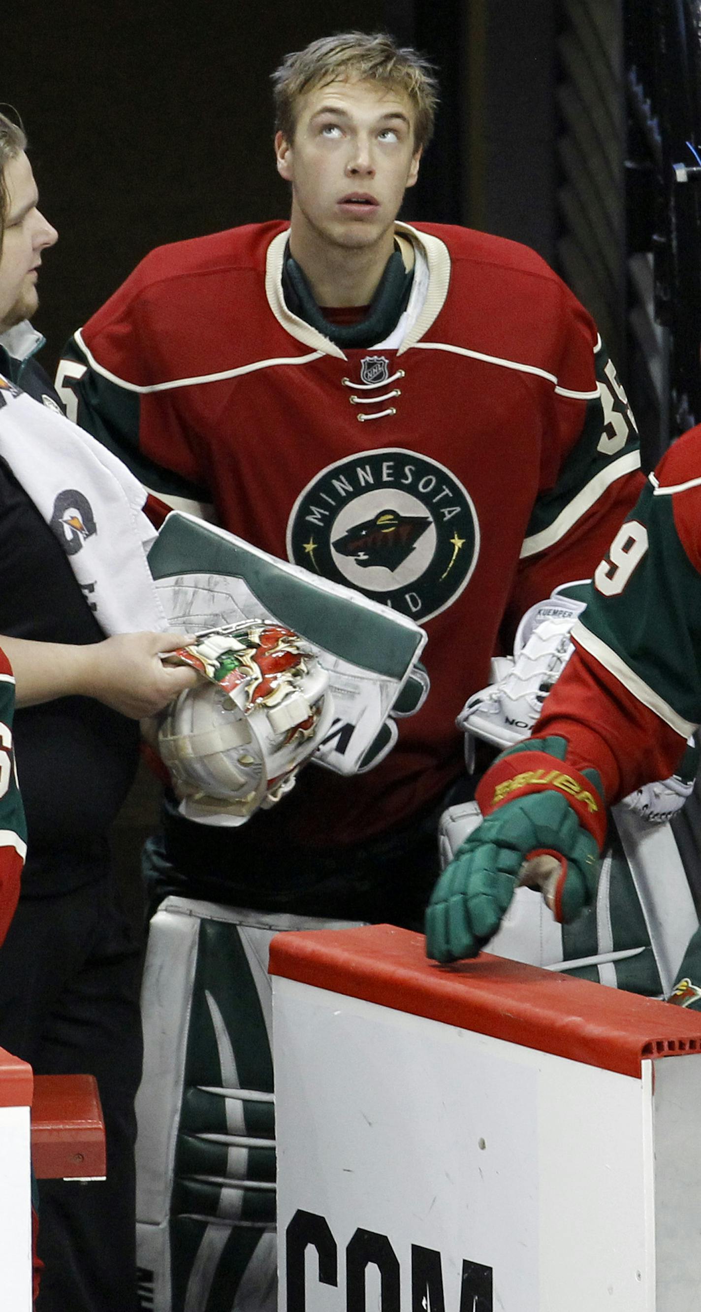 Minnesota Wild goalie Darcy Kuemper, left, looks up at the scoreboard after being replaced in the net by Niklas Backstrom during the third period of an NHL hockey game against the Anaheim Ducks in St. Paul, Minn., Friday, Dec. 5, 2014. The Ducks won 5-4. (AP Photo/Ann Heisenfelt) ORG XMIT: MIN2014122220103185