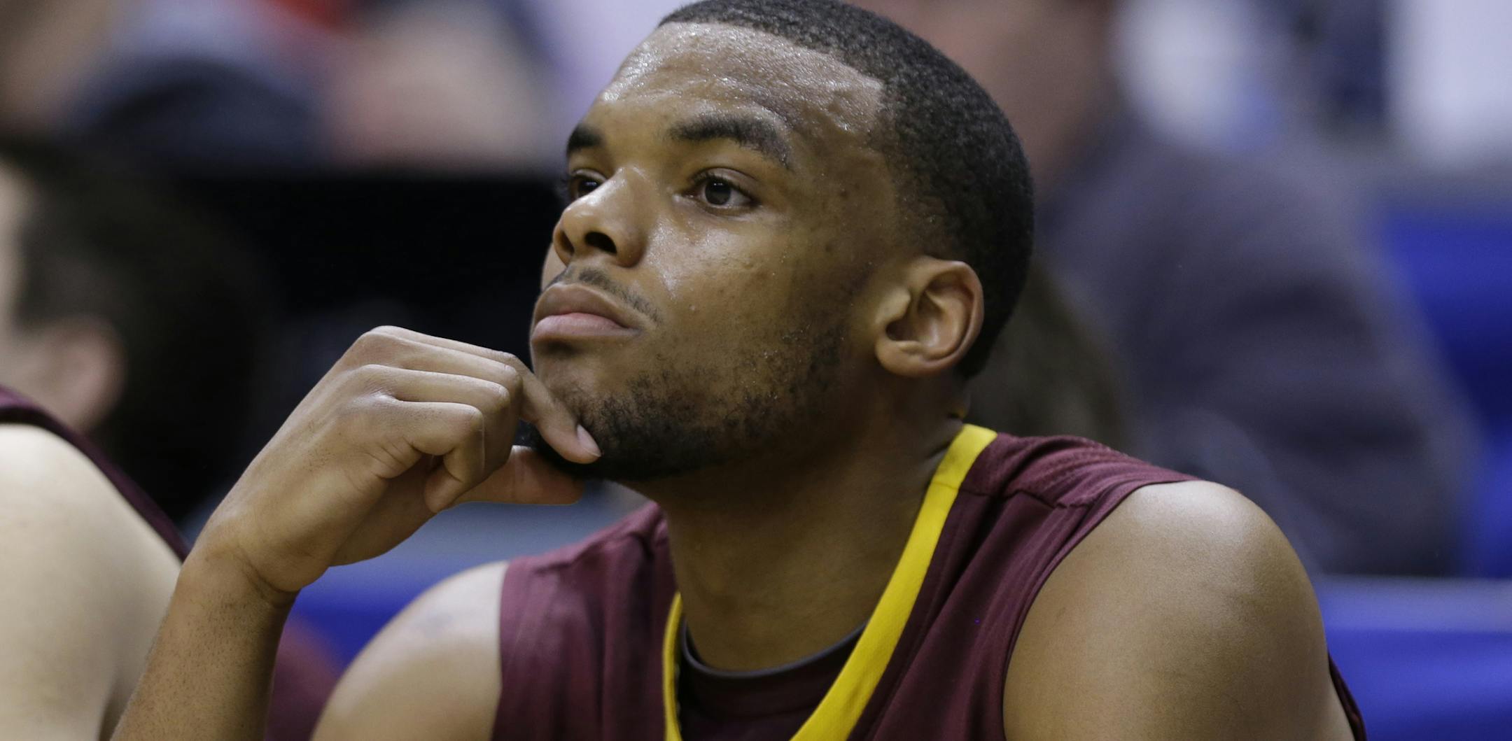 Minnesota guard Andre Hollins watches from the bench in the second half of an NCAA college basketball game against Wisconsin in the quarterfinals of the Big Ten Conference tournament Friday, March 14, 2014, in Indianapolis. Wisconsin won 83-57. (AP Photo/Michael Conroy)