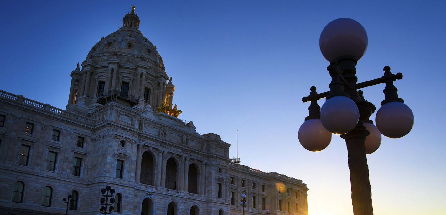 The sun rises behind the Minnesota State Capitol as lawmakers continued their work inside on Wednesday, May 24, 2017 in St. Paul, Minn. The Minnesota Legislature blew past a self-imposed 7 a.m. Wednesday deadline to finish work on a $46 billion budget. The House had several major votes remaining, and the Senate hadn&#xed;t taken any votes overnight as hope evaporated for a tidy wrapup to the five-month session. (Glen Stubbe/Star Tribune via AP) ORG XMIT: MIN2017052415565162 ORG XMIT: MIN17052415