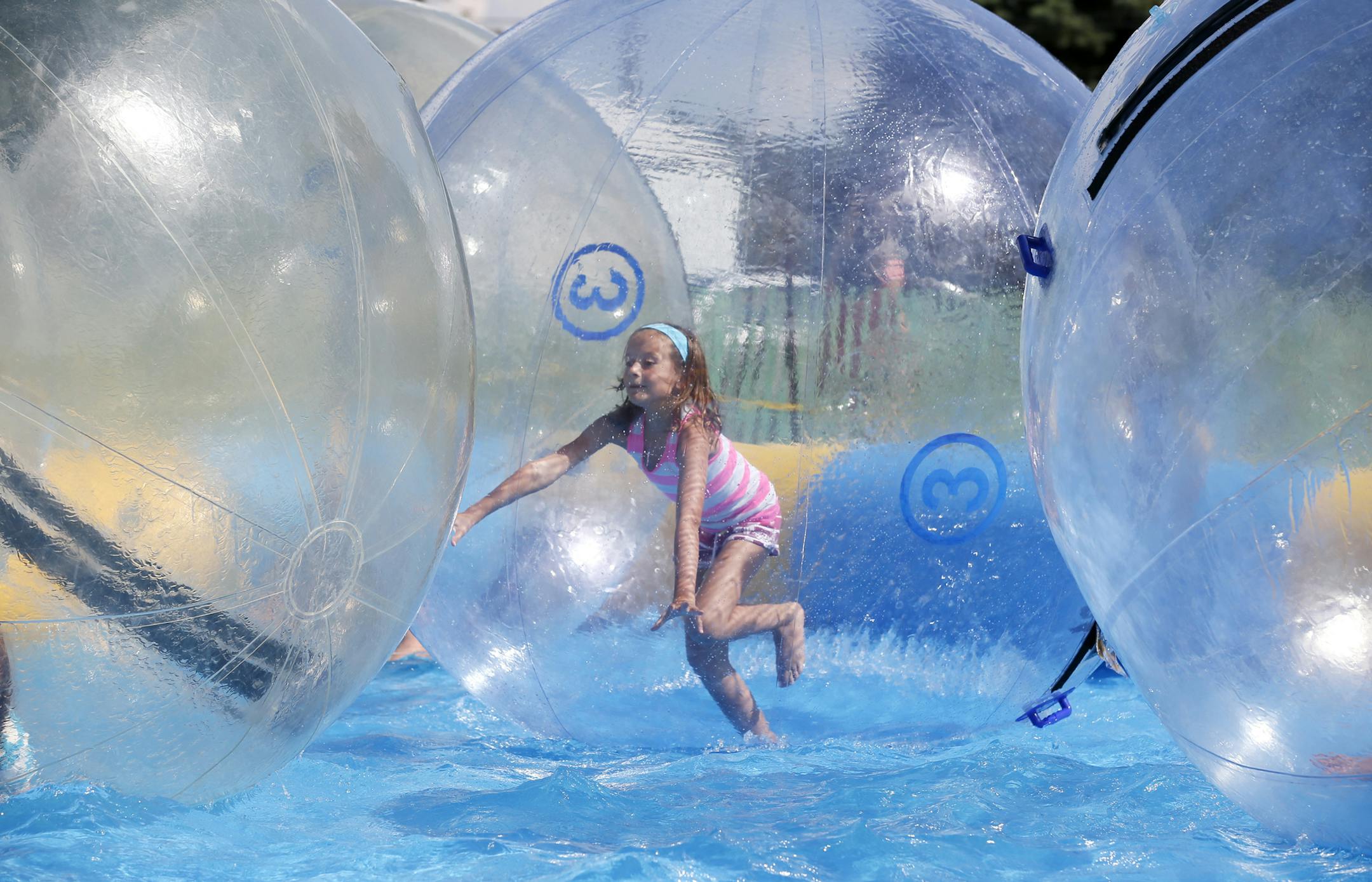 Audrey Anderson 8, of Lake Elmo tried to walk on water inside of large a plastic ball during the 142nd annual Washington County fair in Baytown MN. July 30,2013.] JERRY HOLT ‚Ä¢ jerry.holt@startribune.com