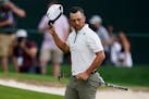 Xander Schauffele waves after completing the second round of the Wells Fargo Championship at Quail Hollow