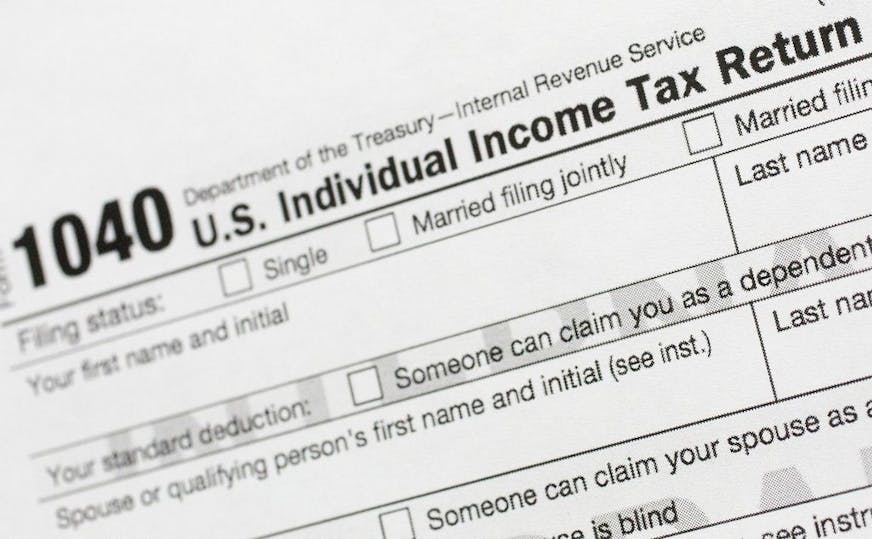 FILE - This July 24, 2018, file photo shows a portion of the 1040 U.S. Individual Income Tax Return form. The Trump administration is working on plans to delay the April 15 federal tax deadline for most individual taxpayers as well as small businesses. Treasury Secretary Steven Mnuchin told Congress on Wednesday, March 11, 2020, that the administration is "looking at providing relief to certain taxpayers and small businesses who will be able to get extensions on their taxes."