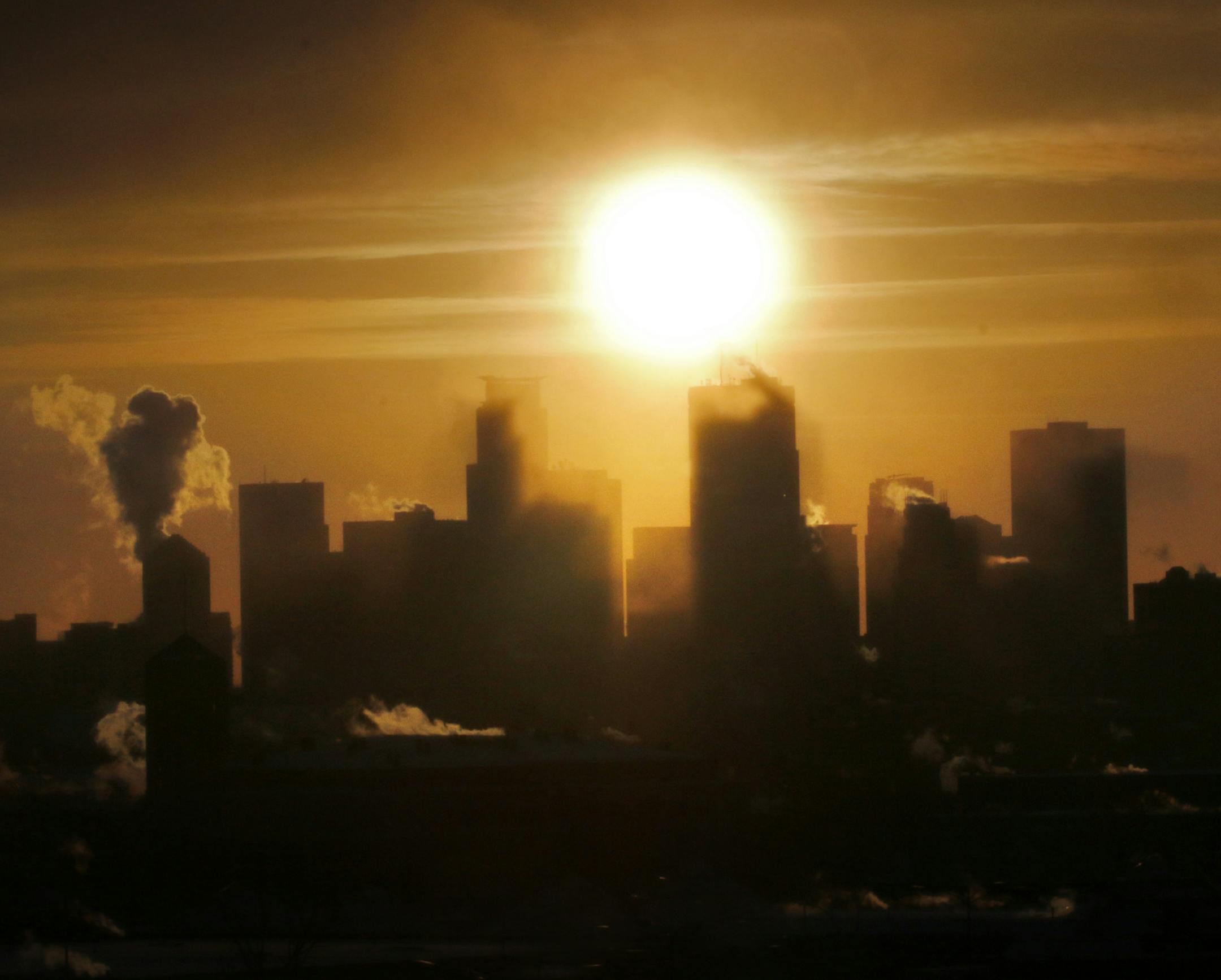 On a day when most people hunkered down inside to avoid the bitter cold, forced to observe the world from their TV or frost covered window, it was a pleasant sight to see the sun set on this frigidly cold day like here over a steaming Minneapolis skyline.] BRIAN PETERSON ‚Ä¢ brianp@startribune.com Minneapolis, MN 01/06/2013