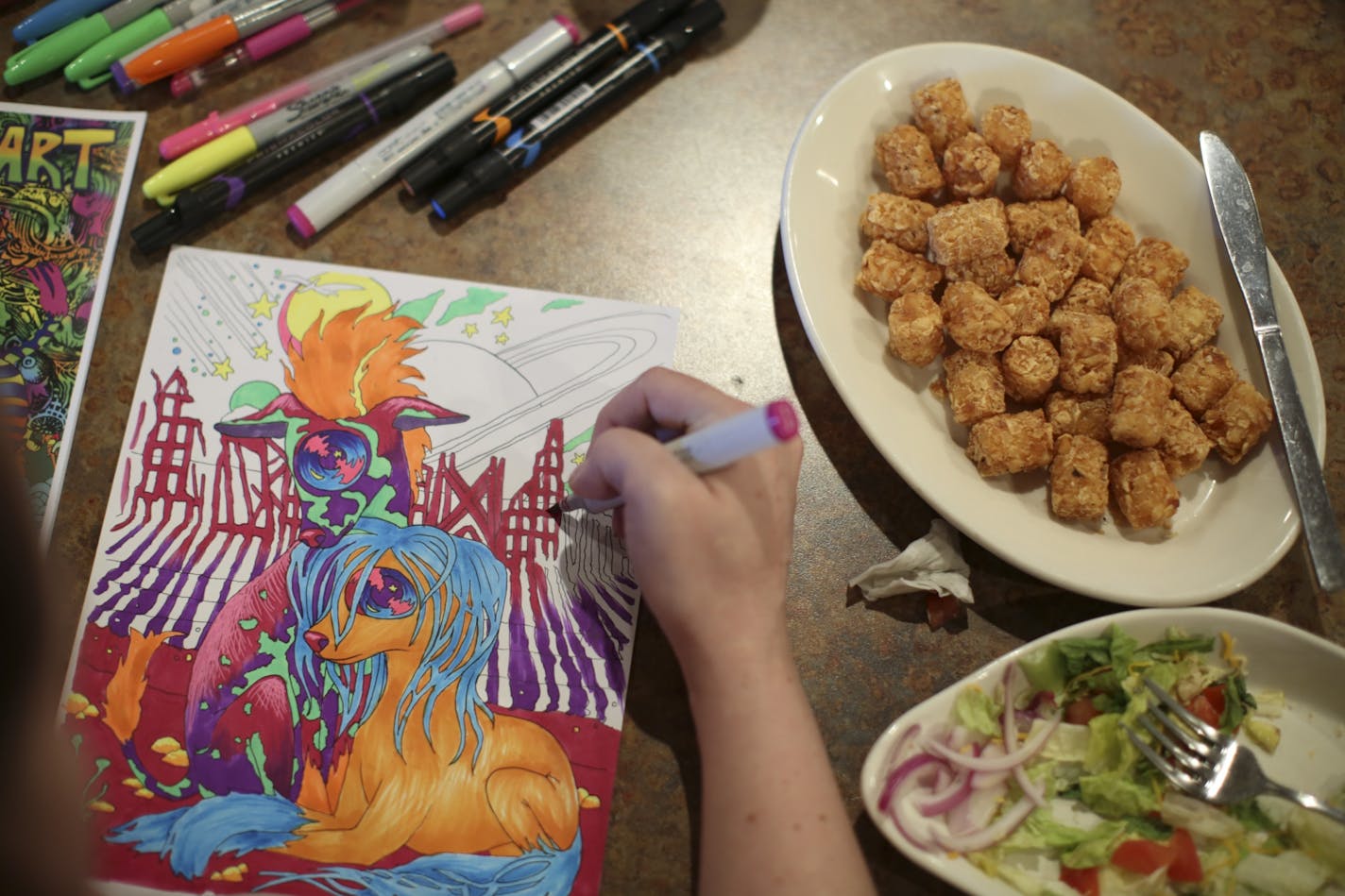 Bonnie Edwigenburg colored one of her own designs during the Thursday evening meeting of the Birdtown Coloring Club. An accomplished artist, it was her first time attending a meeting of the coloring club.