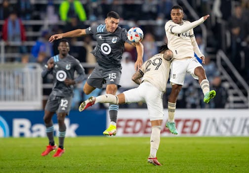 Minnesota United defender Michael Boxall heads down a ball while being pressured by two Los Angeles FC players in the second half Saturday.