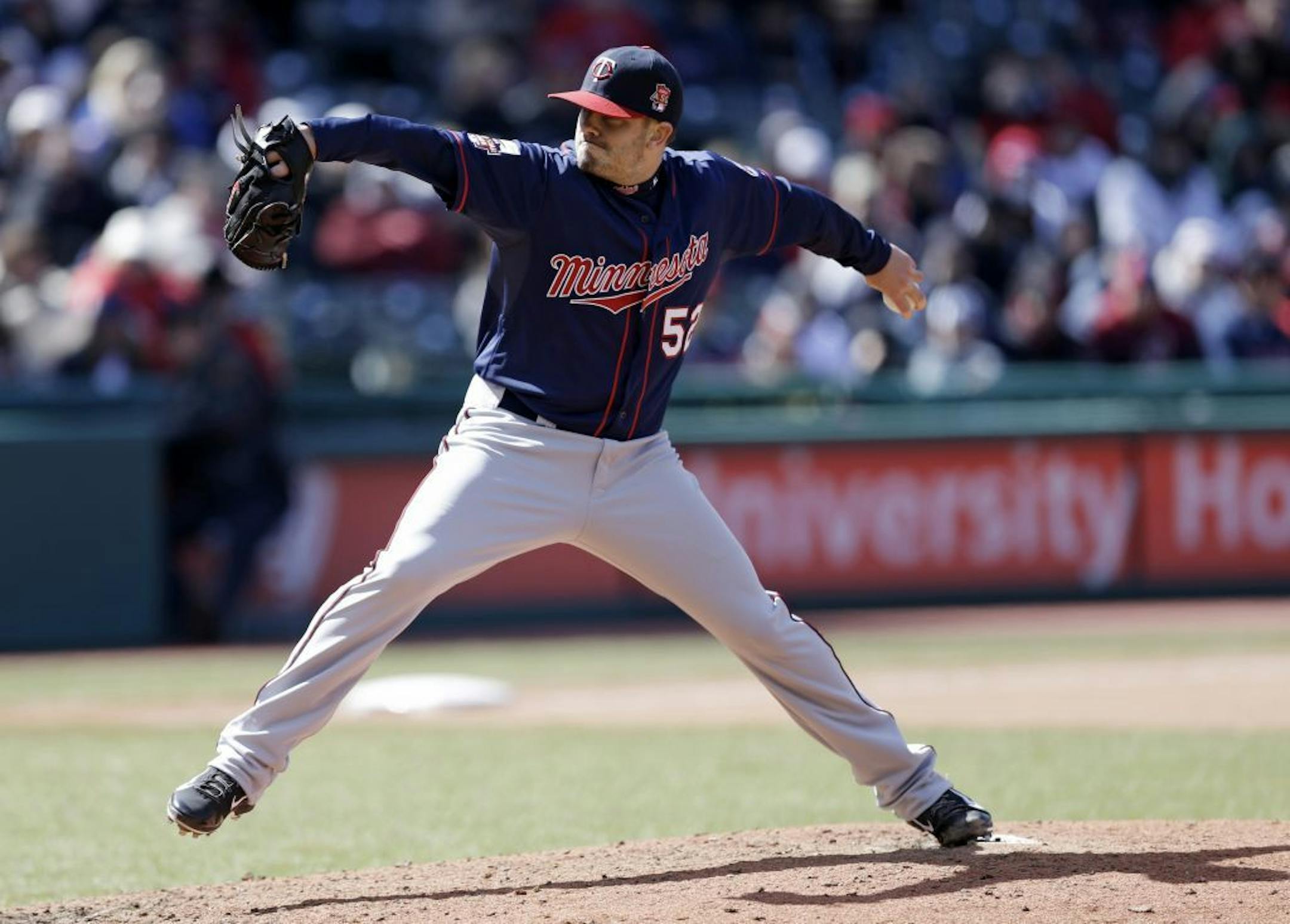 Minnesota Twins relief pitcher Brian Duensing throws in the sixth inning of a baseball game against the Cleveland Indians, Saturday, April 5, 2014, in Cleveland.
