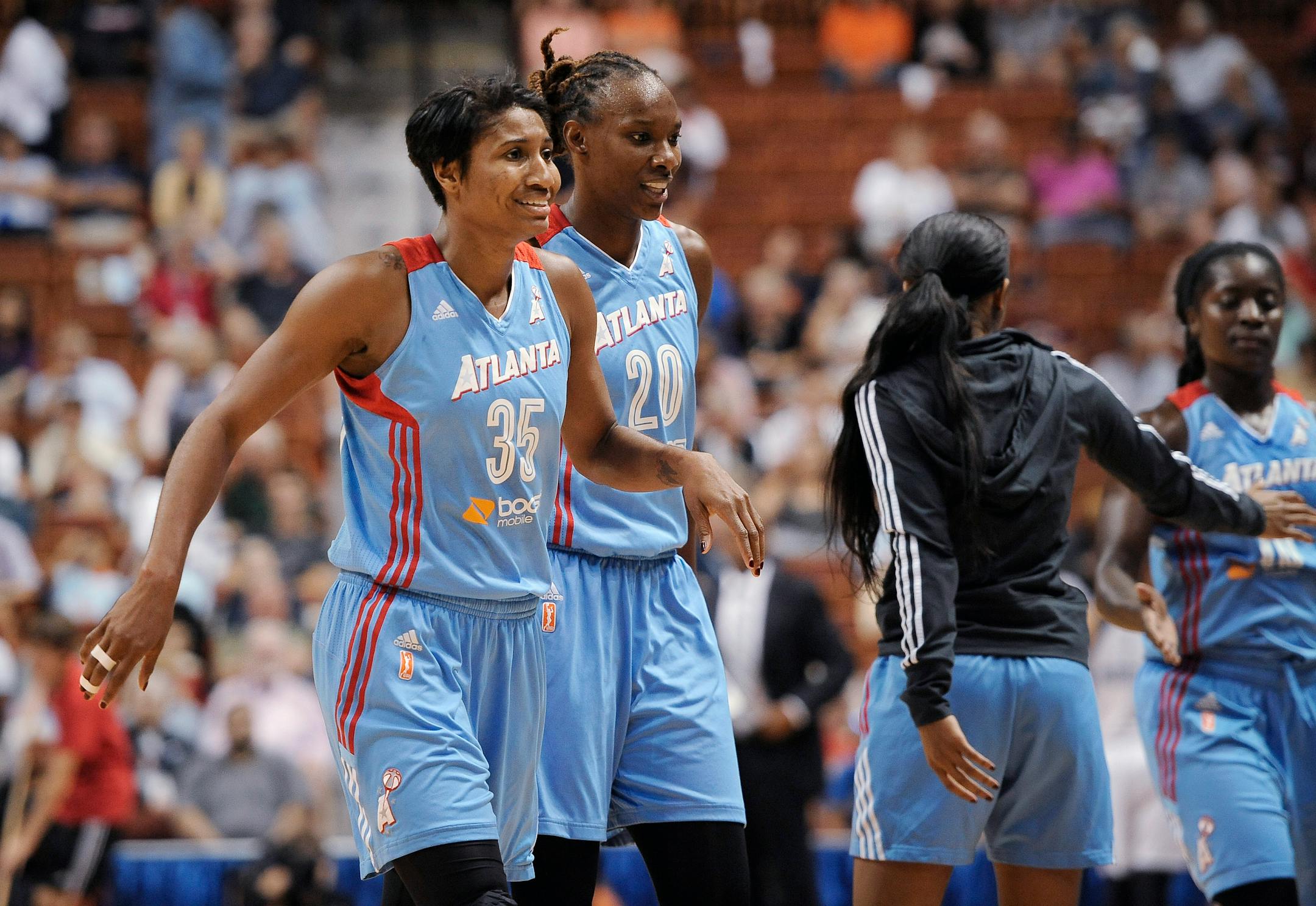 Atlanta Dream's Angel McCoughtry, left, and Sancho Lyttle react as they walk of the court during the second half of a WNBA basketball game against the Connecticut Sun, Sunday, Aug. 23, 2015, in Uncasville, Conn. The Dream won 102-92. (AP Photo/Jessica Hill)