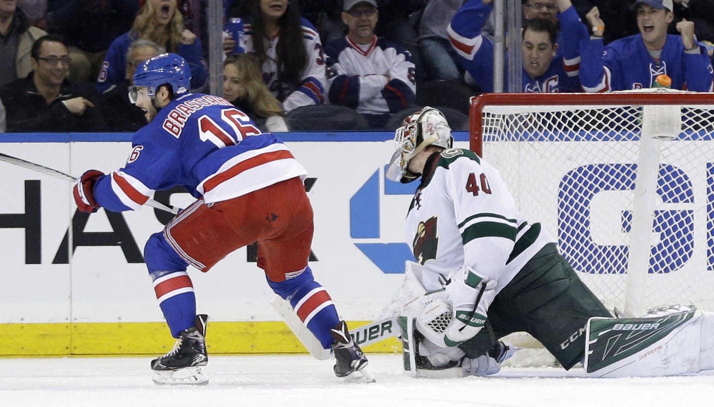 New York Rangers center Derick Brassard (16), left, reacts after scoring the go-ahead goal past Minnesota Wild goalie Devan Dubnyk (40) during the third period of the NHL hockey game, Thursday, Feb. 4, 2016, in New York. The Rangers defeated the Wild 4-2. (AP Photo/Seth Wenig)