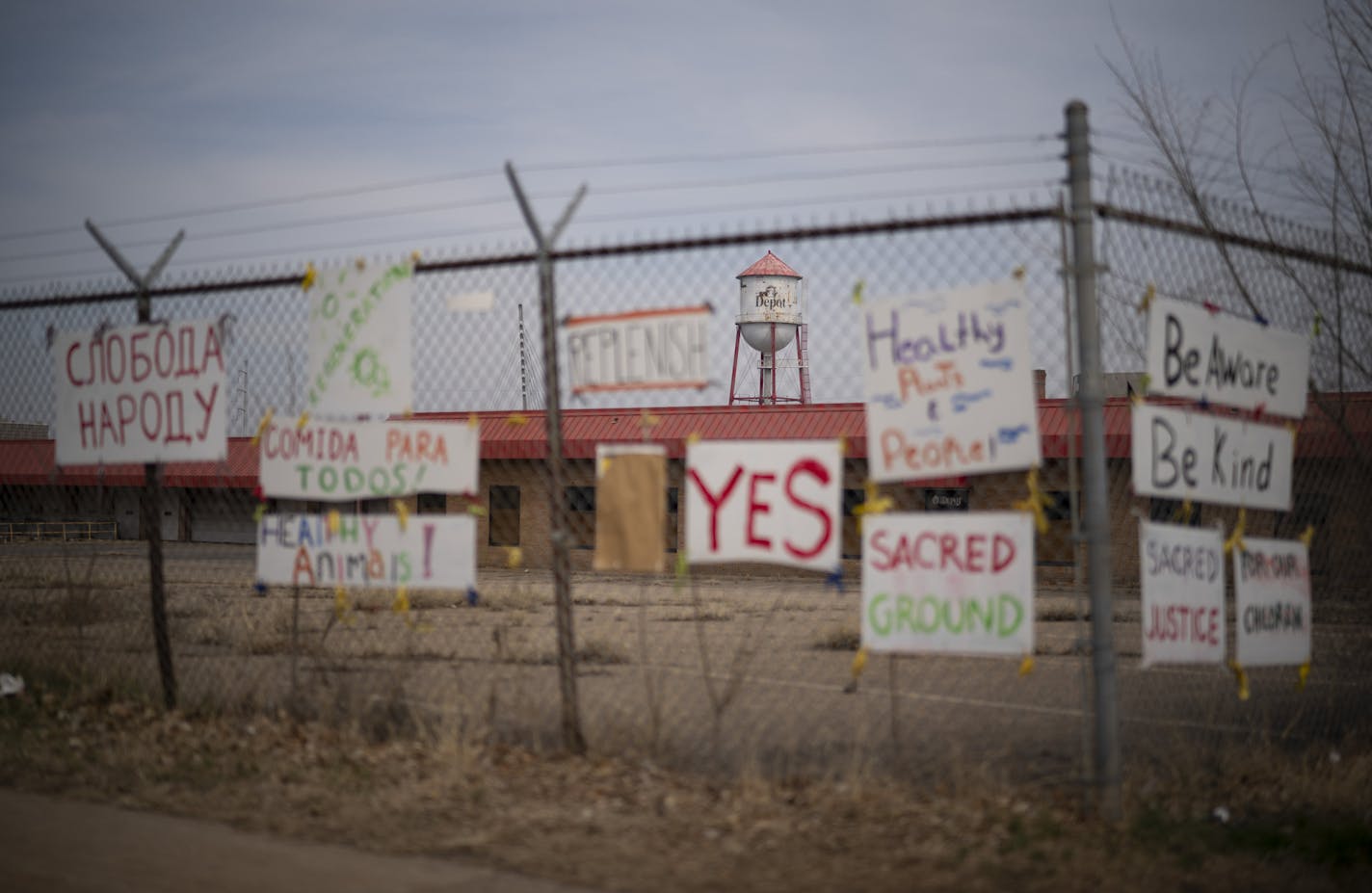 Signs supporting a community role for the Roof Depot have been affixed to the fence surrounding the property.