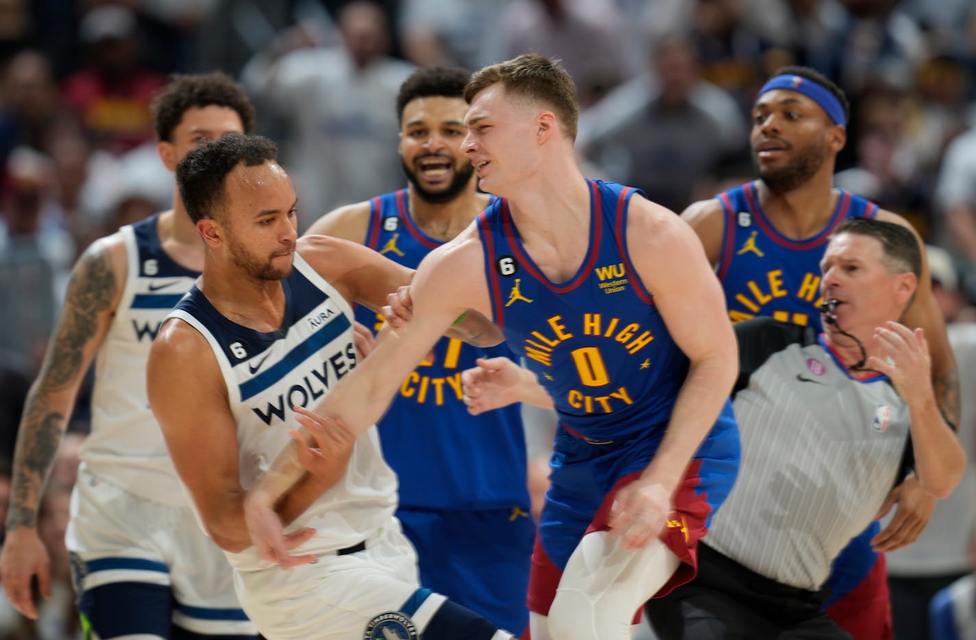 Minnesota Timberwolves forward Kyle Anderson, left, gets in a row with Denver Nuggets guard Christian Braun in the second half of Game 1 of an NBA basketball first-round playoff series Sunday, April 16, 2023, in Denver. (AP Photo/David Zalubowski)