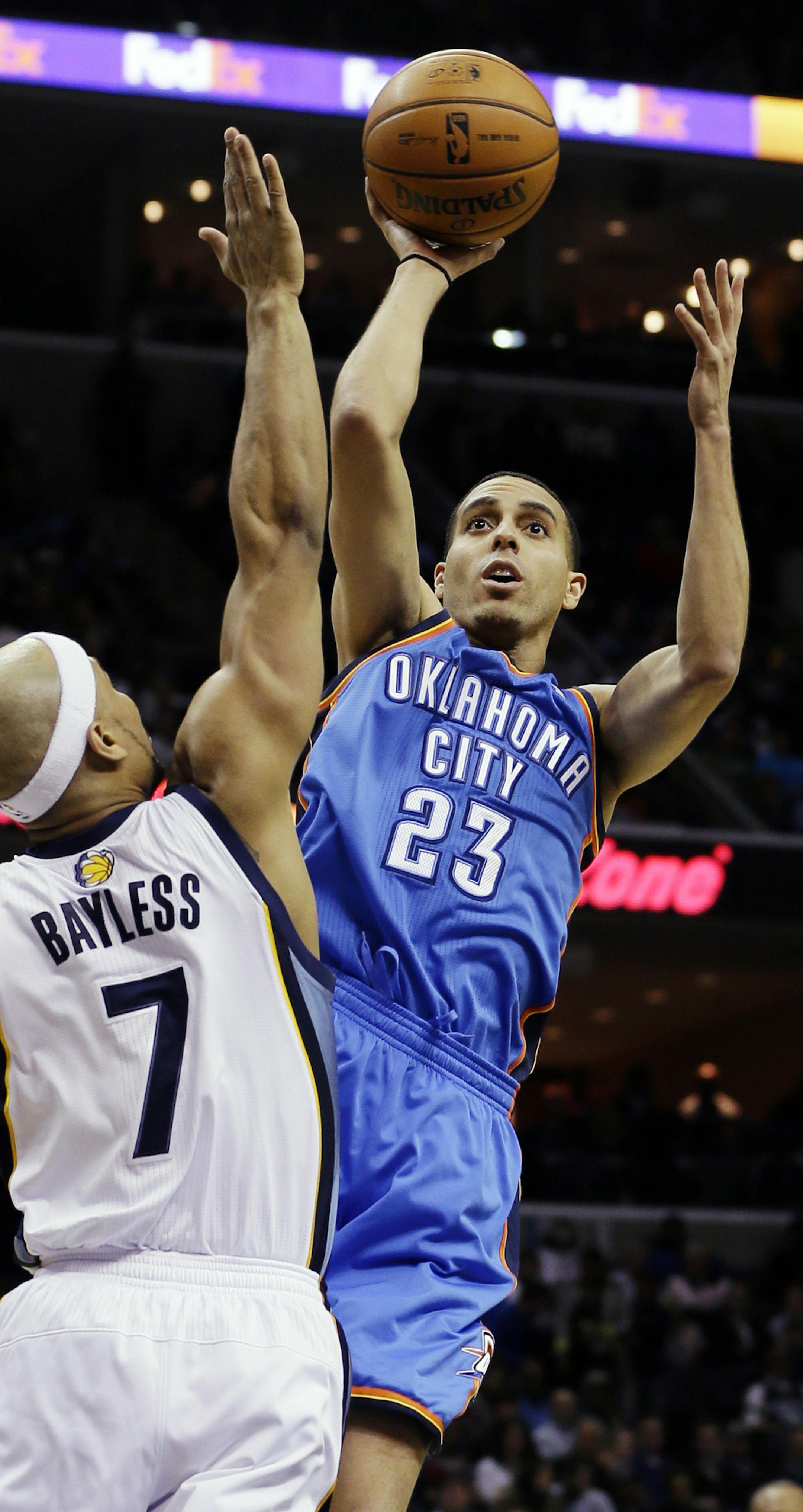 Oklahoma City Thunder's Kevin Martin (23) shoots over Memphis Grizzlies' Jerryd Bayless (7) during the first half of an NBA basketball game in Memphis, Tenn., Wednesday, March 20, 2013. (AP Photo/Danny Johnston) ORG XMIT: TNDJ103