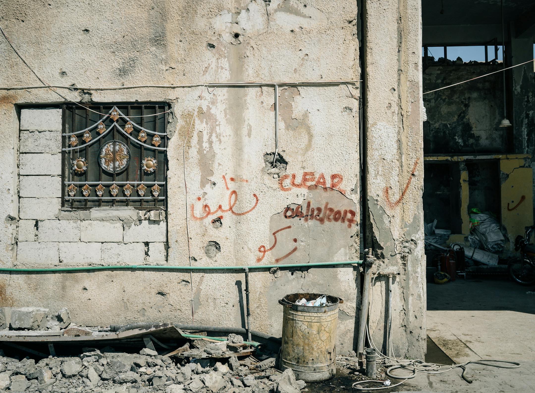 Graffiti marks a building that has been cleared of unexploded ordnance in Raqqa. Most of the city is strewn with ordnance left by U.S.-allied forces and improvised explosive devices left by fleeing Islamic State militants.