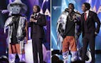 This combination of photos released by Fox shows NFL wide receiver Antonio Brown in a hippo costume as he stands with host Nick Cannon, left, and Brow