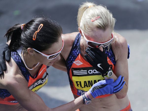 Shalane Flanagan, right, held her hand to her face as she is embraced by Duluth's Kara Goucher after finishing the 2013 running of the Boston Marathon
