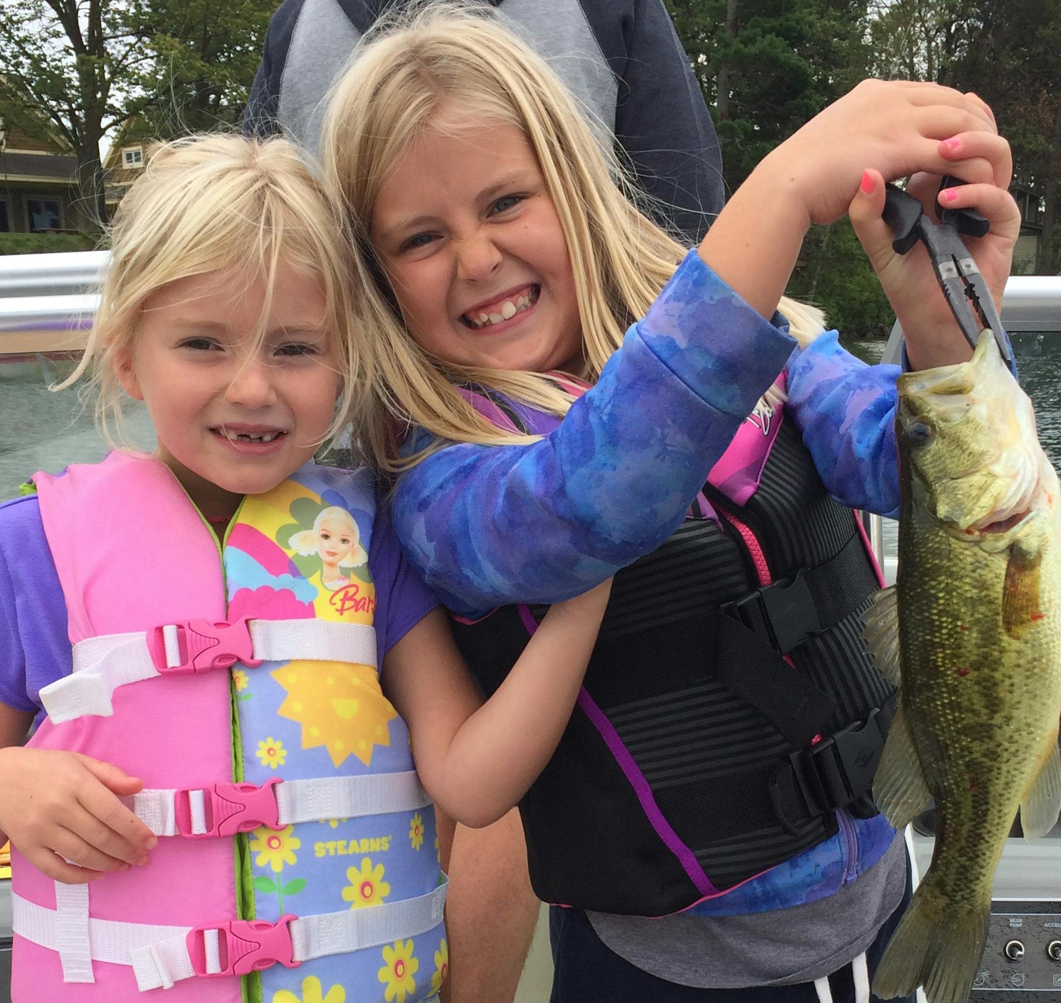 YOUNG ANGLERS Lydia and Annika Peterson of Minneapolis caught this largemouth bass on Sylvan Lake in the Brainerd area. Lydia, 8, caught it with a minnow, reeled it in and her sister, Annika, 6, netted the fish.