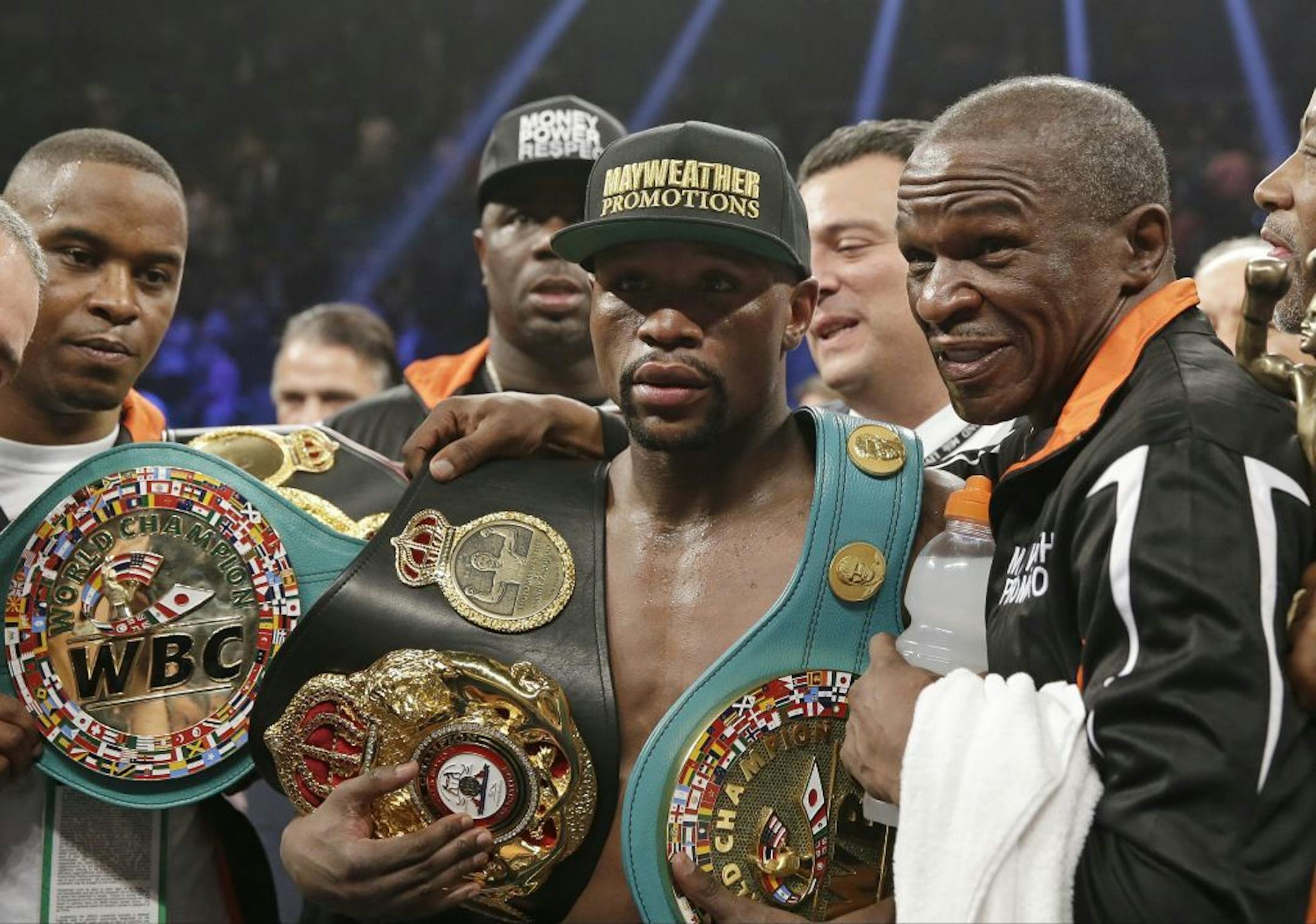 Floyd Mayweather Jr., left, poses with his champion's belts and his father, head trainer Floyd Mayweather Sr., after his victory over Manny Pacquiao, from the Philippines, in their welterweight title fight on Saturday, May 2, 2015 in Las Vegas.