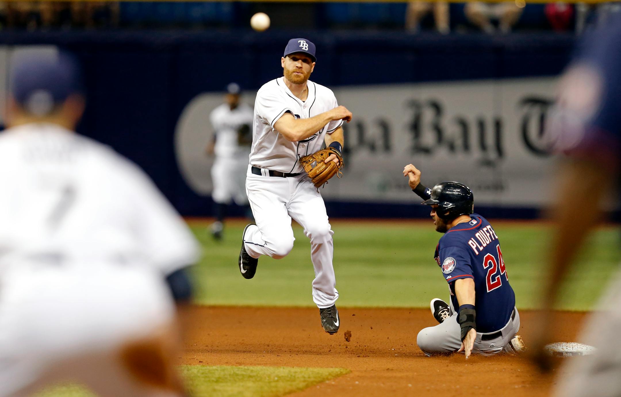 Tampa Bay Rays second baseman Logan Forsythe follows through on a throw to first past a sliding Minnesota Twins' Trevor Plouffe to complete the double play on batter Torii Hunter during the fifth inning of a baseball game Thursday, Aug. 27, 2015, in St. Petersburg, Fla. (AP Photo/Mike Carlson)