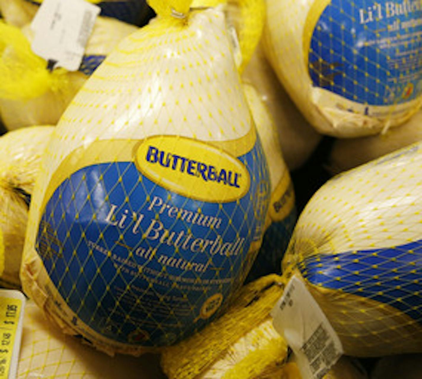 A freezer case full of frozen turkeys for sale ahead of Thanksgiving.