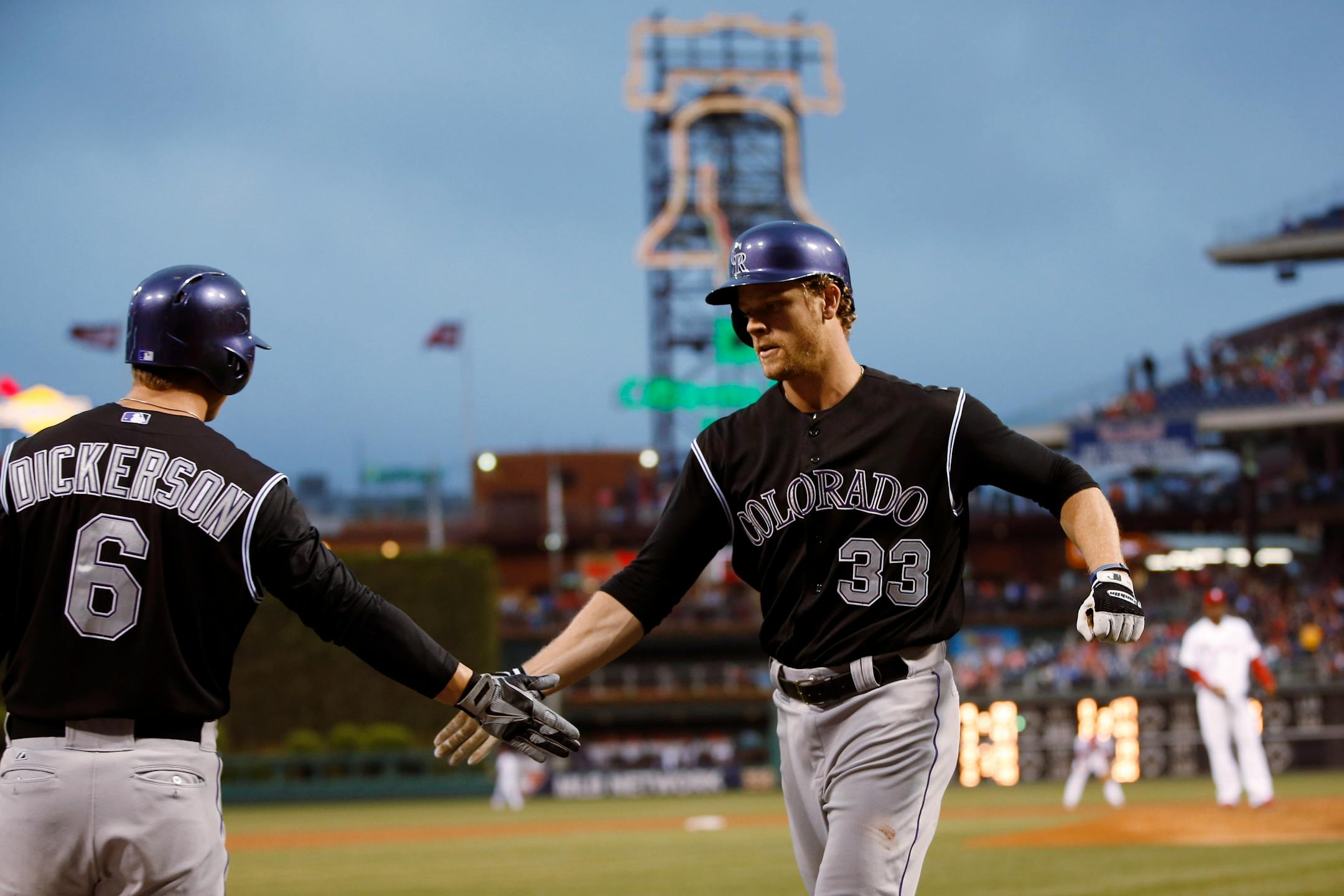 Colorado Rockies' Justin Morneau, right, celebrates with Corey Dickerson after hitting a home run off Philadelphia Phillies starting pitcher Roberto Hernandez during the third inning of a baseball game, Wednesday, May 28, 2014, in Philadelphia. (AP Photo/Matt Slocum)