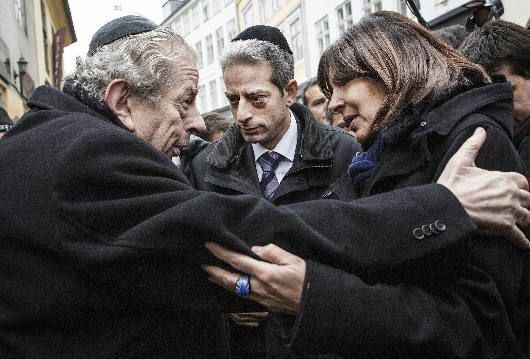 Former Chief Rabbi Bent Melchior, left, embraces Paris Mayor Anne Hidalgo with French Chief Rabbi Moise Lewin at centre, during a visit the Synagogue in Copenhagen, Monday, Feb. 16, 2015, after the attacks at the weekend. The slain gunman suspected in the deadly Copenhagen attacks was a 22-year-old with a history of violence and Danish authorities say he may have been inspired by Islamic terrorists — and possibly the Charlie Hebdo massacre in Paris. (AP Photo/Polfoto, Stine Bidstrup) DENM