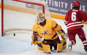 Badgers forward Lacey Eden scored against Gophers goaltender Skylar Vetter in the third period of Wisconsin’s 5-1 victory Saturday at Ridder Arena. 