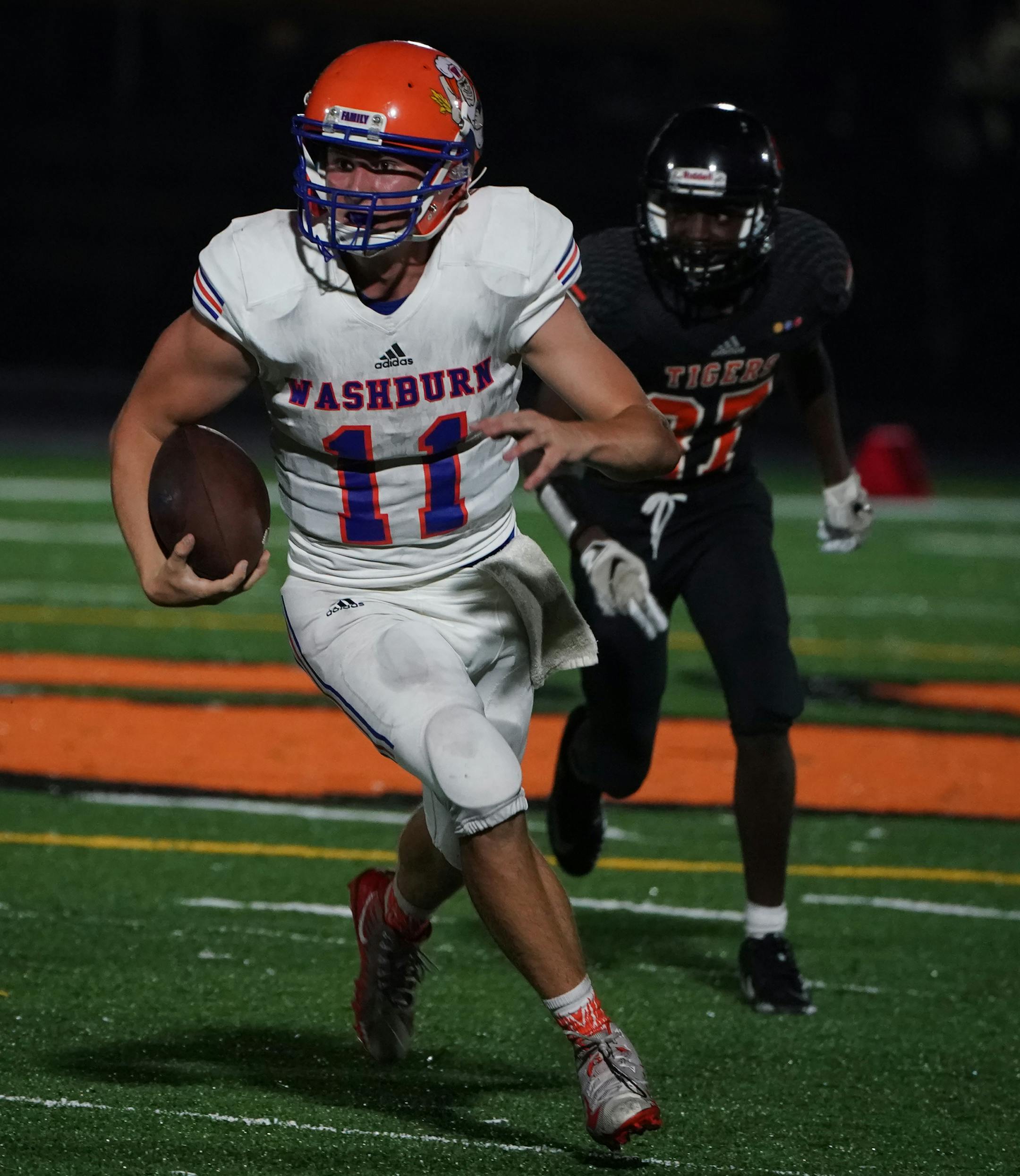 Washburn quarterback Andrew Gotziamann (11) scrambled past the line of scrimmage in the second half. ] Shari L. Gross • shari.gross@startribune.com Minneapolis South hosted Washburn High School for a football game on Friday night, Sept. 20, 2019. South's homecoming was the first game played under the new stadium lights.