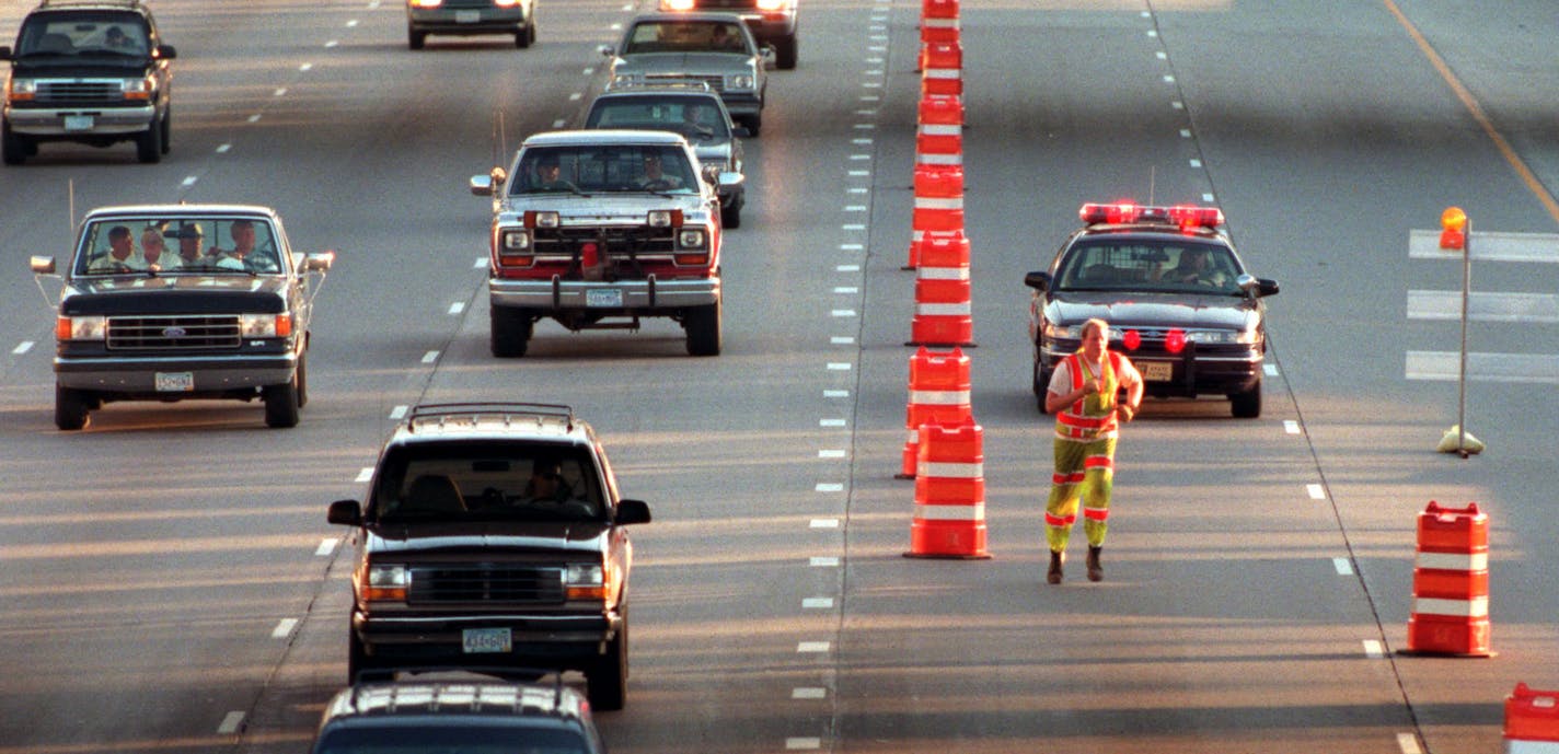 Brian Gilmore an employee of Warning Lites of Minnesota, dashes towards a barrel in the north bound lane of35E in downtown St. Paul Thursday evening. The Minnesota Department of Transportation will be resurfacing a 6 mile section of Interstate Hwy 35E form St. Paul north through Maplewood and Little Canada to Shoreveiw. That 6 mile section will be closed nightly during the hours of 8pm- 5:30 am. Most of the work is being done at night to lessen problems for commuters. ORG XMIT: MIN20130705193549