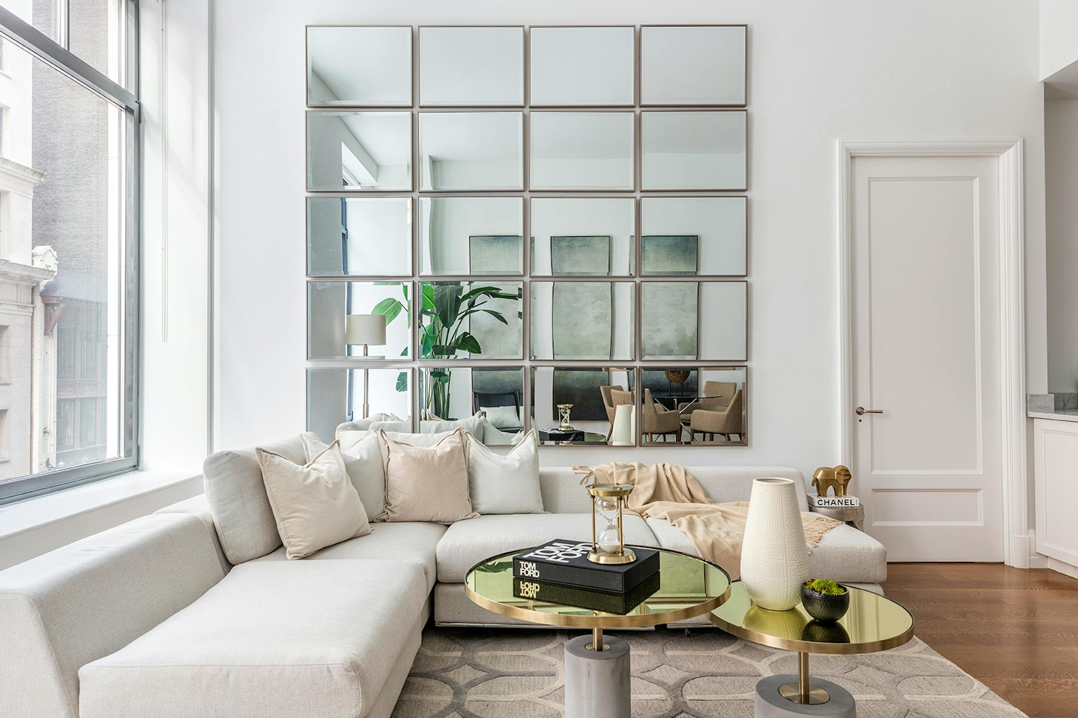A wall with a grid of mirrors arranged with five rows of four mirrors each.