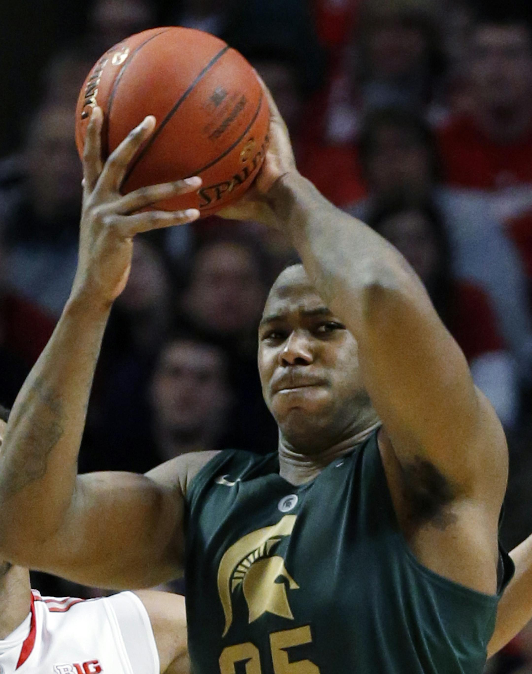 Michigan State's Derrick Nix (25) looks to pass while being defended by Ohio State's Amir Williams (23) during the second half of an NCAA college basketball game at the Big Ten tournament Saturday, March 16, 2013, in Chicago. (AP Photo/Charles Rex Arbogast)